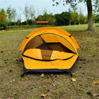 Yellow bivvy tent with the door open, mesh inner visible