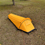 Yellow bivvy tent seen from above, showing the tapered foot end