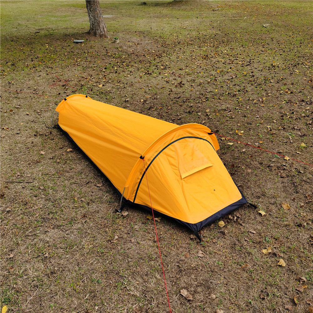 Yellow bivvy tent seen from above, showing the tapered foot end