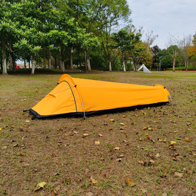 Ultralight bivvy tent in yellow pitched in woodland