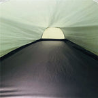 Inside the tent looking down its length, showing the groundsheet and far vent