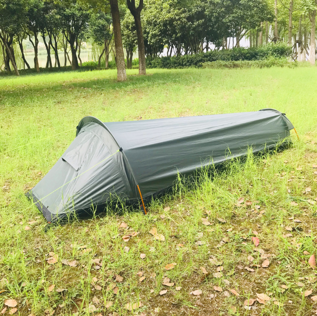Ultralight bivvy tent in army green pitched on grass