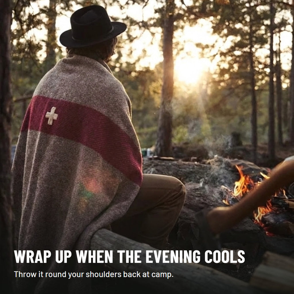 Blanket wrapped round a camper's shoulders at camp in the evening